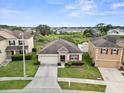 An aerial view showcases this property and neighboring homes, with lush greenery and blue skies at 5793 Dornich Dr, Auburndale, FL 33823