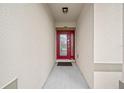 Inviting front entrance featuring a red door and sheltered entryway at 5793 Dornich Dr, Auburndale, FL 33823