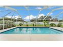 Relaxing screened-in pool area offers a private oasis with a sparkling pool and verdant landscaping at 601 Pintail Cir, Auburndale, FL 33823