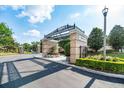 Community entrance with a decorative archway, stone pillars, and manicured landscaping at 6357 Ashley Dr, Lakeland, FL 33813
