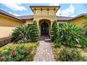 Lovely front entrance with elegant landscaping and a brick walkway that leads to the front door at 6357 Ashley Dr, Lakeland, FL 33813
