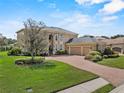 Elegant two-story house boasting a brick driveway and attached three-car garage at 6542 Eagle Ridge Way, Lakeland, FL 33813
