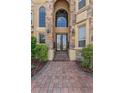 Close-up of the home's entrance with stone accents and stylish double doors at 6542 Eagle Ridge Way, Lakeland, FL 33813