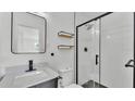 Modern bathroom featuring a black framed shower, floating shelves, and sleek fixtures at 6543 Tula Ln, Lakeland, FL 33809