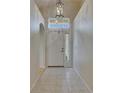 Bright entryway featuring tile flooring, a modern light fixture, and a transom window at 1003 Clearpointe Way, Lakeland, FL 33813