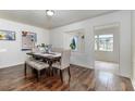 Bright dining room featuring hardwood floors, a wooden dining table, and ample natural light at 102 Pike St, Auburndale, FL 33823