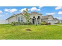Well-maintained single-story home with lush green lawn and classic architectural details at 1146 Enclave Ct., Auburndale, FL 33823