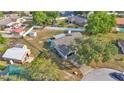 Bird's eye view of a home with a large, fenced backyard, storage sheds, and surrounded by mature shade trees at 1423 Ridgegreen N Loop, Lakeland, FL 33809