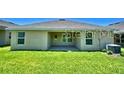 A spacious backyard featuring a covered patio perfect for outdoor enjoyment at 1529 Leamington Ln, Winter Haven, FL 33884