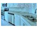 Contemporary kitchen design showcasing stainless steel dishwasher and granite countertops at 1529 Leamington Ln, Winter Haven, FL 33884