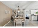 Open dining area with modern decor, adjacent to kitchen with white cabinets at 1648 Skinner St, Lakeland, FL 33801