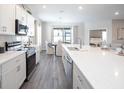Bright kitchen featuring white cabinets, stainless steel appliances, and a large island with seating at 1823 Daystar Dr, Haines City, FL 33844