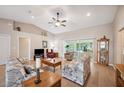 Bright living room with vaulted ceilings, neutral walls, hardwood floors, and sliding glass doors to the lanai at 188 Morning Dew Ct, Winter Haven, FL 33884
