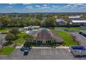 Community clubhouse with parking, pool, and lush landscaping at 2025 Sylvester Rd # P4, Lakeland, FL 33803