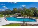 Beautiful community pool with palm trees and covered lounge area for relaxation at 2025 Sylvester Rd # P4, Lakeland, FL 33803