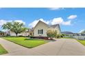 Side view of a home with a long driveway, well-manicured lawn, and mature landscaping at 2025 Viewpoint Landings Rd, Lakeland, FL 33810