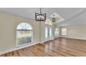 Inviting foyer with wood laminate flooring, modern lighting, and large windows with blinds at 2255 Couples Dr, Lakeland, FL 33813