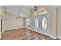 Bright entryway with wood laminate flooring, updated fixtures, and stylish double doors at 2255 Couples Dr, Lakeland, FL 33813