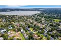 Wide aerial view of the community, showcasing a lake and the green home's location at 2731 Coventry Ave, Lakeland, FL 33803