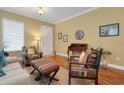 Cozy living area with hardwood floors, a stylish desk, and eclectic décor touches at 2731 Coventry Ave, Lakeland, FL 33803