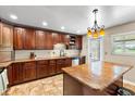 Well-equipped kitchen with stainless appliances, wood cabinets, granite counters, and a functional center island layout at 2810 Gary Ln, Lakeland, FL 33812