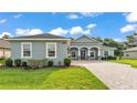 Beautiful home featuring a large three-car garage, well-kept lawn, and elegant brick driveway at 3176 Pearly Dr, Lakeland, FL 33812