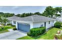 A single-story home featuring well-kept landscaping, a driveway, and a blue two-car garage at 3618 Highland Fairways Blvd, Lakeland, FL 33810