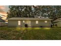 Image of the back of the house showing the backyard, windows, door, and AC unit on the ground at 3829 Abbott Ln, Lakeland, FL 33810