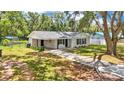 Single-story home featuring a lengthy driveway, neutral paint, and a covered carport at 3829 Abbott Ln, Lakeland, FL 33810