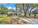 Charming single-story home boasting a lengthy driveway, neutral paint, and a covered carport at 3829 Abbott Ln, Lakeland, FL 33810