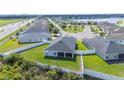 Aerial view of a home with a screened lanai and a pristine, fenced backyard offering privacy and space at 3883 Sandhill Crane Dr, Lakeland, FL 33811