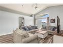 Bright living room featuring vaulted ceilings, wood floors, and comfortable seating around a coffee table at 436 Lady Diana Dr, Davenport, FL 33837