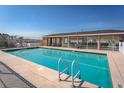 Community pool with a clear blue water, featuring a gated fence, and a lounging area at 436 Lady Diana Dr, Davenport, FL 33837