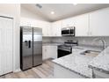 Bright kitchen featuring stainless steel appliances, ample counter space, and white cabinets at 4486 Rapallo Ave, Winter Haven, FL 33884
