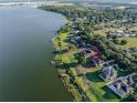 An aerial view of a lakeside home highlighting the private yard and dock at 4808 Juliana Reserve Dr, Auburndale, FL 33823