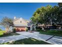 Beautiful home with a well-manicured lawn, a spacious driveway, and an attached two-car garage at 4808 Juliana Reserve Dr, Auburndale, FL 33823