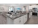 Modern kitchen with a large center island, stainless steel appliances, and an open floor plan at 6060 Barracuda Loop, Wimauma, FL 33598