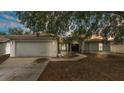 Charming single-story home with a two-car garage, well-maintained lawn, and mature shade trees at 7311 Briarbay Loop, Lakeland, FL 33810