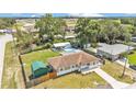 Aerial view showcasing the property's backyard, pool, storage shed, and spacious surroundings at 808 Austin Cir, Bartow, FL 33830