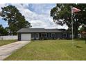 Inviting home with manicured lawn, and an American flag adds patriotic charm to this well-maintained property at 5732 Sawyer Rd, Lakeland, FL 33810