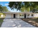 Charming single-story home boasting a carport and a dark front door at 3813 Surrey Dr, Orlando, FL 32812