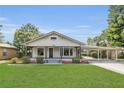 Charming single-story home with a covered porch and carport in a mature setting at 1013 Pennsylvania Ave, Lakeland, FL 33803