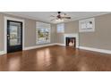 Bright living room features hardwood floors, fireplace, ceiling fan, and natural light at 1013 Pennsylvania Ave, Lakeland, FL 33803