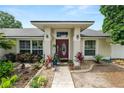 Charming home entrance featuring a decorative front door, manicured landscaping, and accent lighting, creating an inviting curb appeal at 1130 Ewell Rd, Lakeland, FL 33811