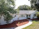 Charming single-story home with a well-maintained lawn and mature trees at 1195 S 1St Ave, Bartow, FL 33830