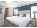 Comfortable main bedroom with a queen bed, natural light, and ensuite bathroom at 1424 Fleur Dr, Davenport, FL 33837