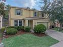 Inviting two-story home with a well-manicured lawn and charming green shutters at 143 Alfani St, Davenport, FL 33896