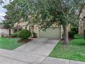 Charming two-story home with a well-manicured lawn and an attached garage at 143 Alfani St, Davenport, FL 33896