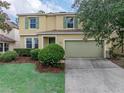Inviting two-story home with a well-manicured lawn and attached two-car garage at 143 Alfani St, Davenport, FL 33896