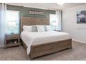 Relaxing main bedroom featuring a large bed, stylish nightstands, and serene decor at 1448 Fleur Dr, Davenport, FL 33837